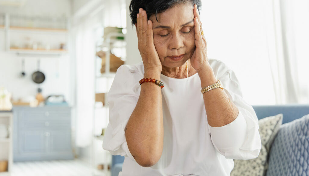 An Elderly Asian Woman Uses Her Hand To Grasp The Head. Old Wome