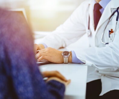 Doctor Reviews a Patient’s Annual Physical Exam Checklist
