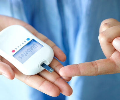 A Woman Holding a Glucose Meter Preparing To Check Her Blood Sugar Type 1 vs Type 2 Diabetes