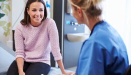 A Female Patient Smiling At Her Nurse During A Birth Control Consultation