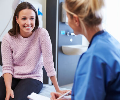 A Female Patient Smiling At Her Nurse During A Birth Control Consultation